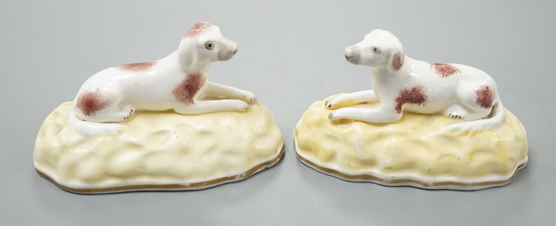 A rare pair of Samuel Alcock porcelain models of recumbent pointers, c.1835–50, impressed mark ‘115’, 8.8 cm long, Unrecorded in Dennis G.Rice Dogs in English porcelain., Provenance: Dennis G.Rice collection